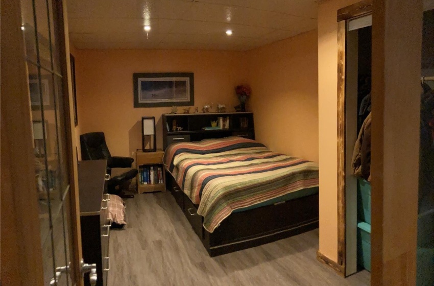 Bedroom with hardwood / wood-style flooring and a drop ceiling