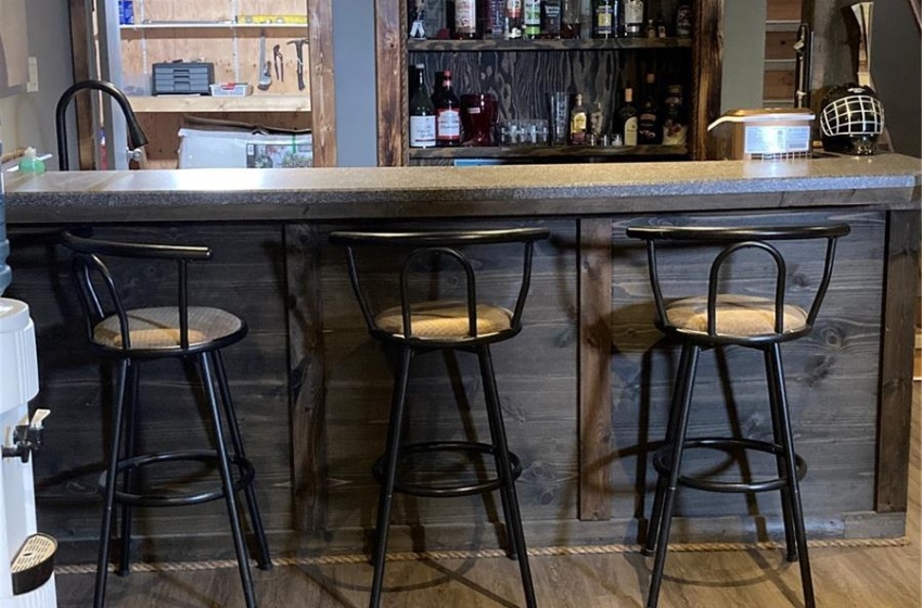 Bar featuring light hardwood / wood-style floors