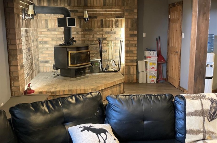 Living room with wood-type flooring and a wood stove