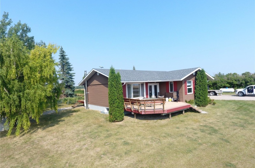 View of front of house with a front yard and a wooden deck