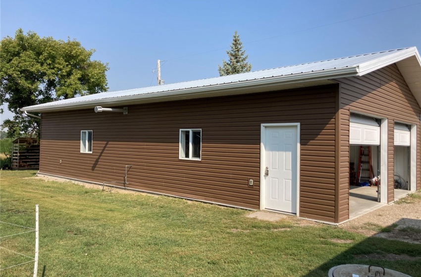 Rear view of property featuring a lawn