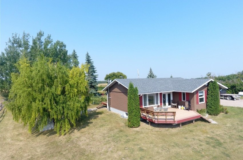 View of front of home with a front lawn and a wooden deck