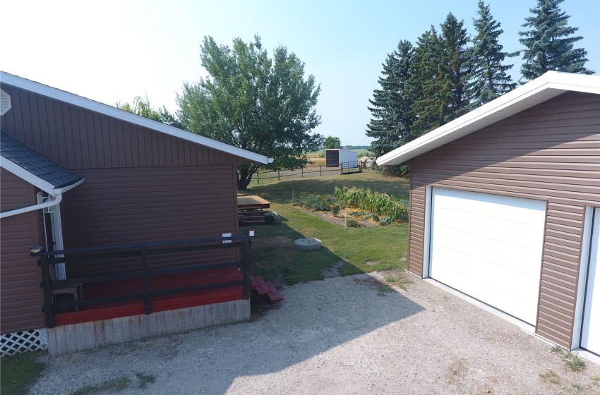 View of property exterior featuring a garage and an outdoor structure