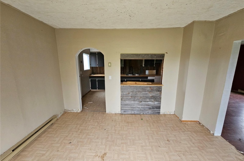 Spare room with a baseboard heating unit, a textured ceiling, and light parquet flooring