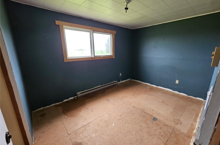 Spare room featuring a baseboard heating unit