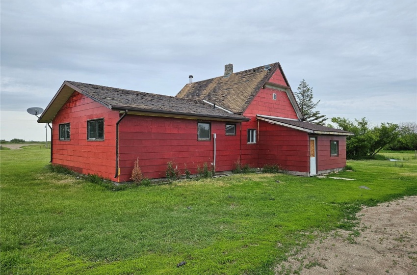 View of side of property featuring a lawn