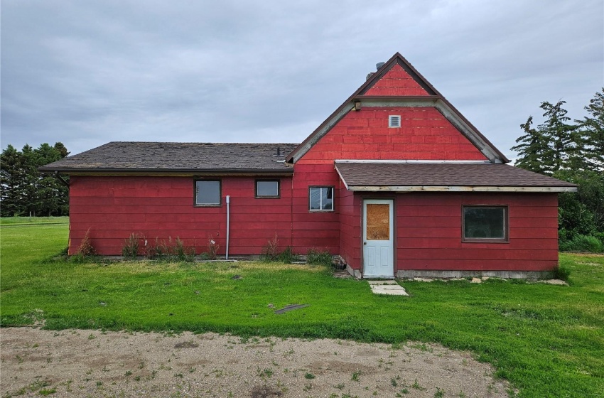 Back of property featuring a lawn