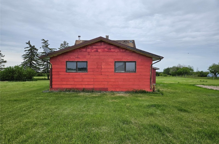 View of side of property featuring a yard