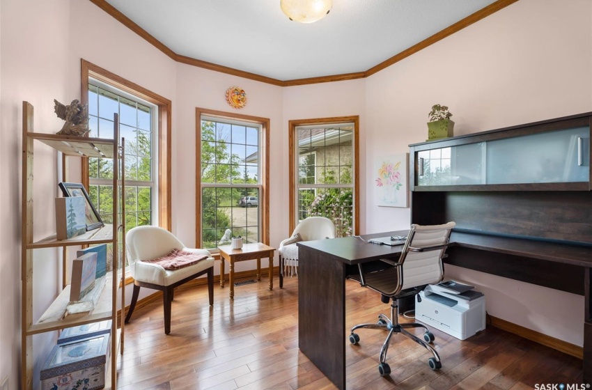 Home office featuring crown molding and hardwood / wood-style floors