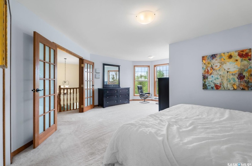 Carpeted bedroom featuring french doors