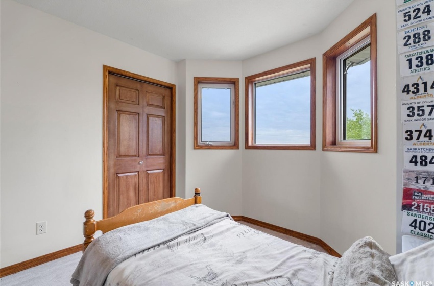 Carpeted bedroom with a closet