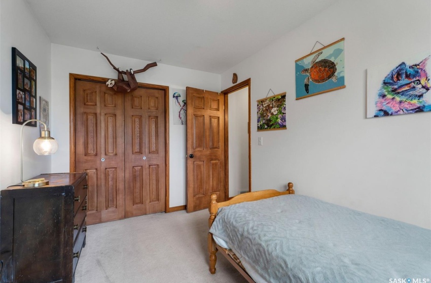 Carpeted bedroom with a closet