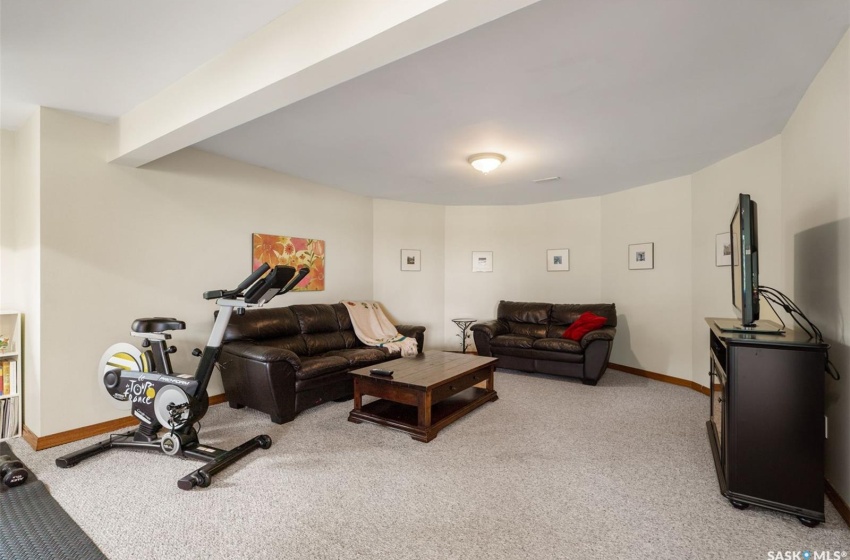 Carpeted living room with beamed ceiling