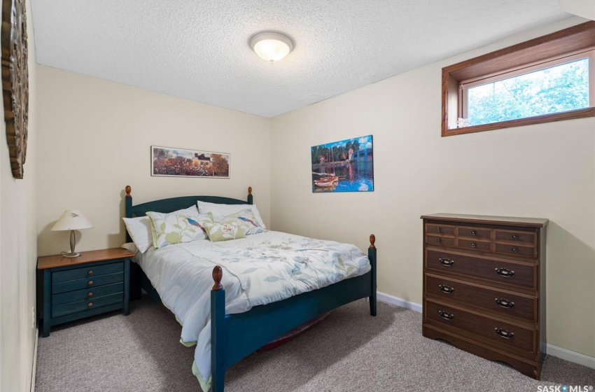 Carpeted bedroom featuring a textured ceiling