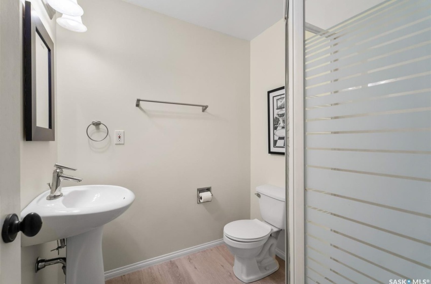 Bathroom featuring hardwood / wood-style flooring and toilet