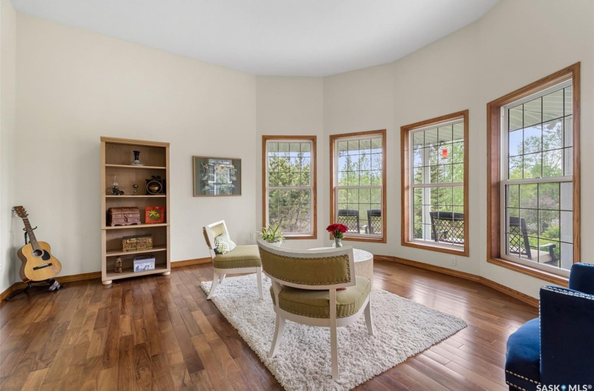 Sitting room with dark hardwood / wood-style flooring and plenty of natural light