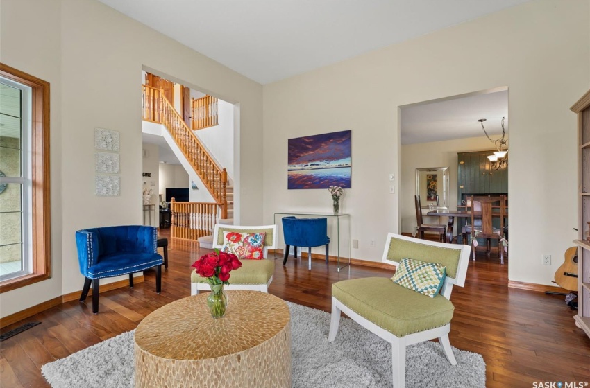 Living room with dark wood-type flooring and a chandelier