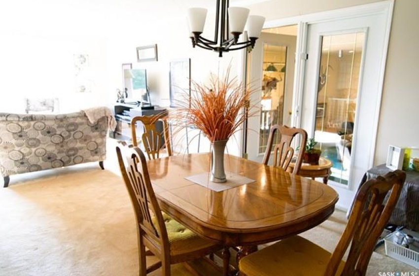 Dining area featuring carpet floors and an inviting chandelier