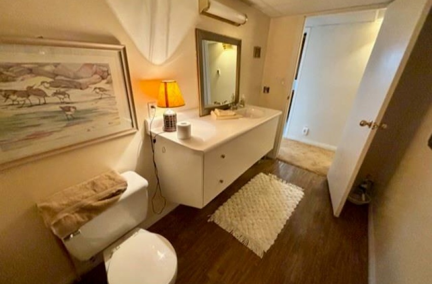 Bathroom featuring hardwood / wood-style flooring and toilet