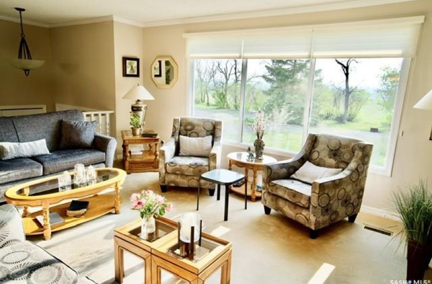 Living room with carpet and crown molding