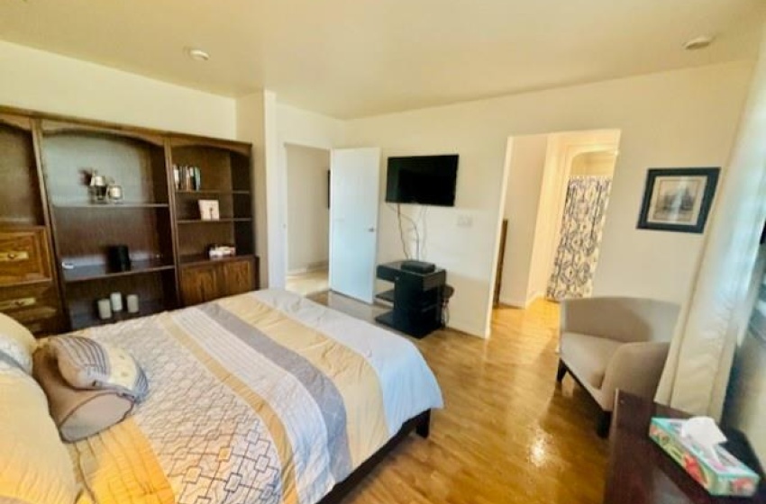 Bedroom with hardwood / wood-style floors