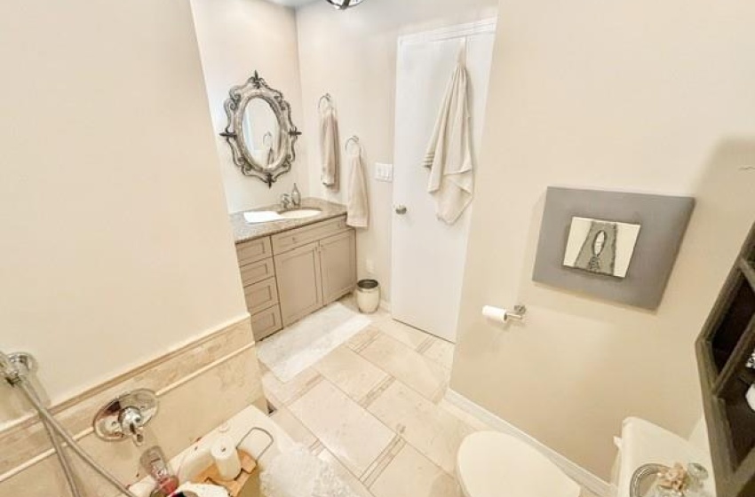 Bathroom featuring tile floors, vanity, and toilet