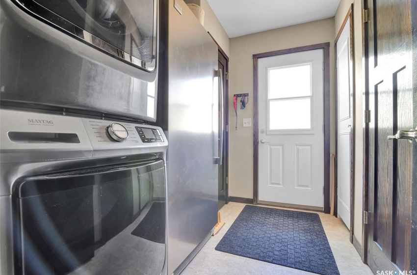 Laundry room featuring stacked washer / dryer