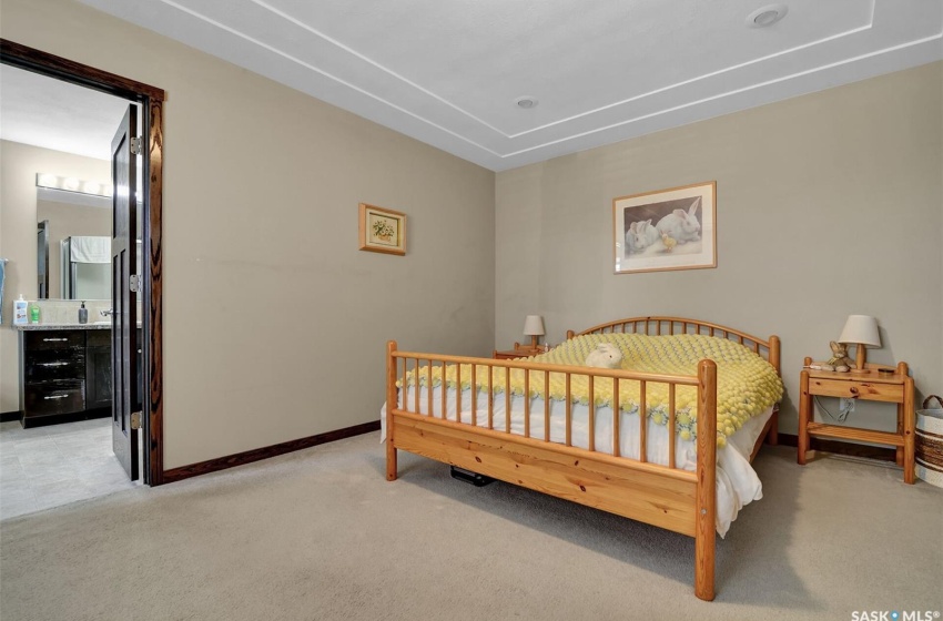 Carpeted bedroom featuring connected bathroom