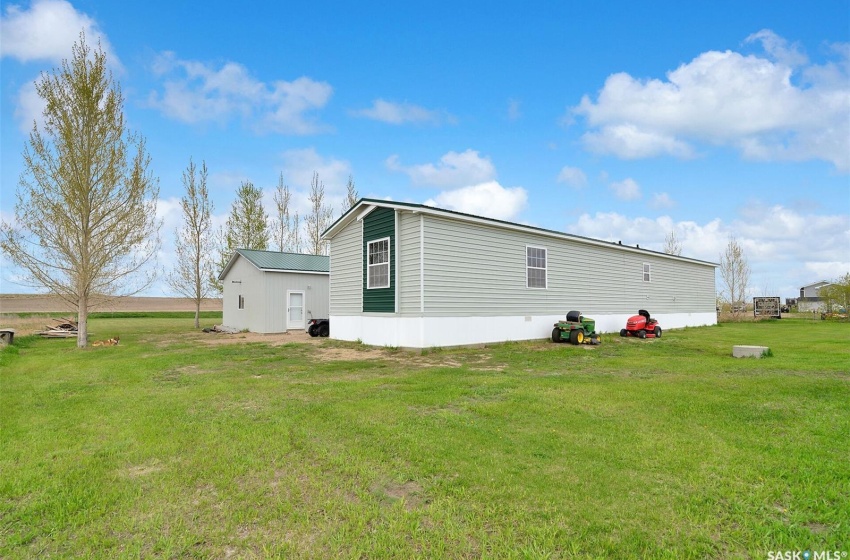 Rear view of house featuring a lawn