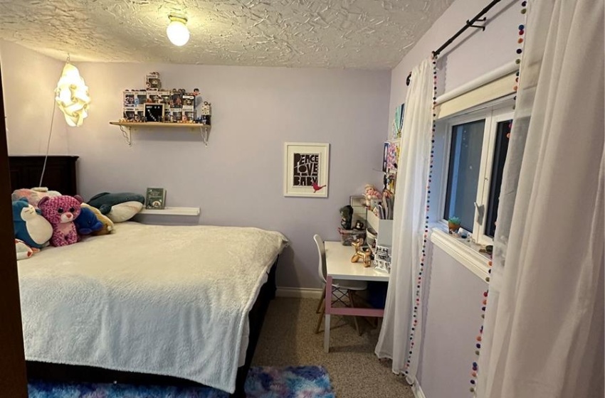 Carpeted bedroom featuring a textured ceiling