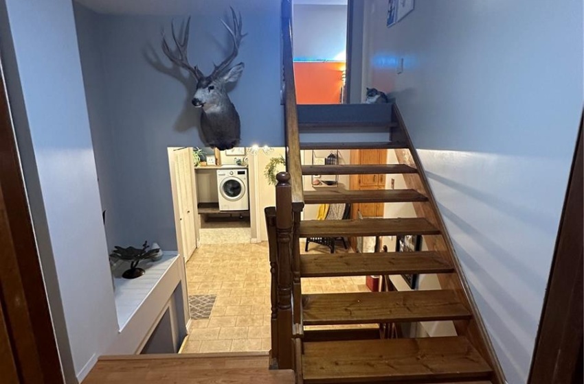 Stairway featuring a textured ceiling, ceiling fan, and hardwood / wood-style floors