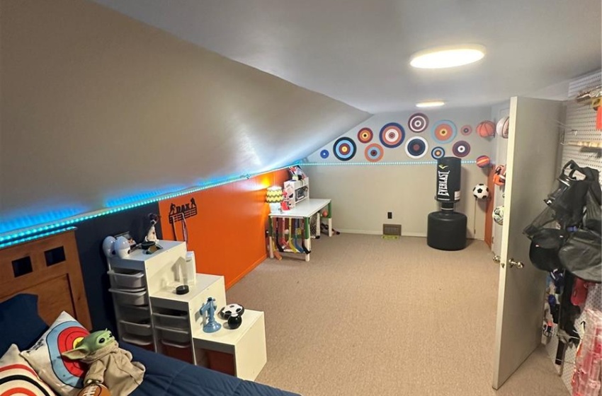 Carpeted bedroom featuring vaulted ceiling