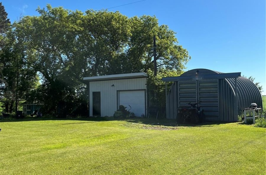 View of yard with an outdoor structure and a garage