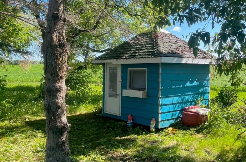 View of home's exterior featuring a yard and a shed