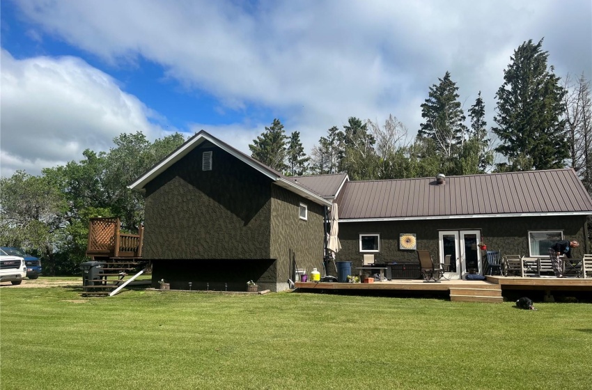 Rear view of house featuring a lawn and a wooden deck