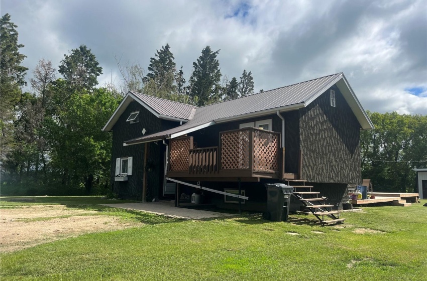 Rear view of property with a lawn and a wooden deck