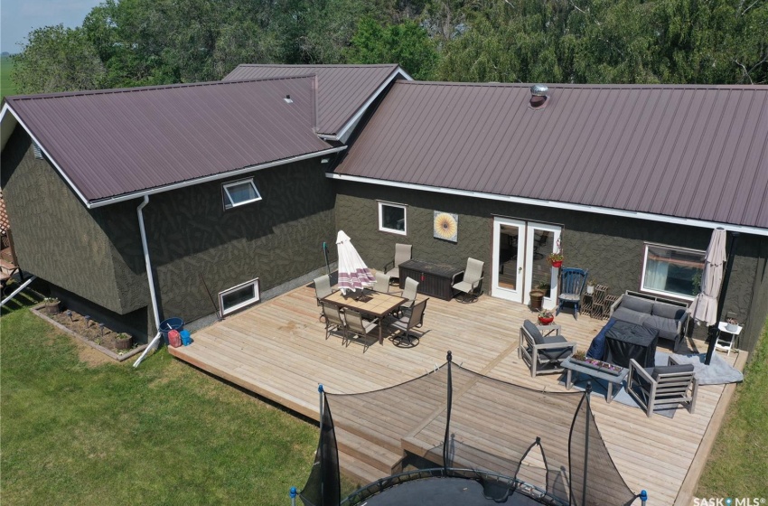 Rear view of property with a deck, outdoor lounge area, french doors, and a yard