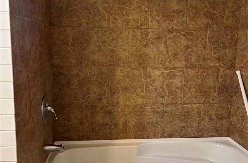 down stairs Bathroom with tiled shower / bath combo and vanity