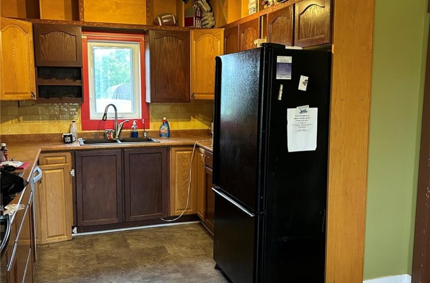 Kitchen with appliances with stainless steel finishes, a textured ceiling, light tile patterned floors, backsplash, and track lighting