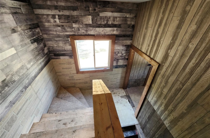 Stairway featuring wooden walls