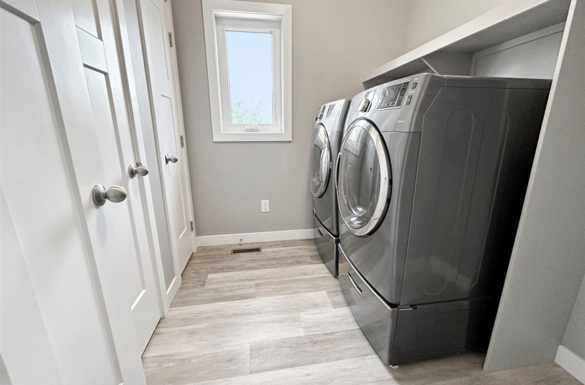 Main floor laundry on the west side of the house along with the Primary Bedroom.