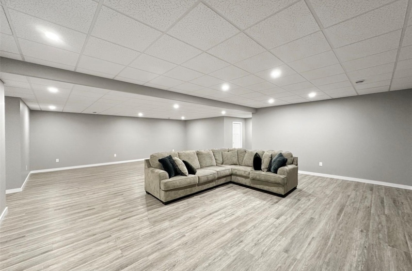 The lower level features an oversized family room made for entertaining with vinyl plank flooring, a drop ceiling and tons of recessed lights.