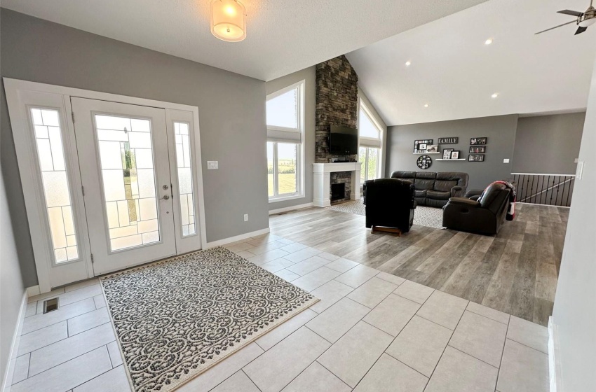 Spacious front foyer welcomes you to the great room adjacent that has a vaulted ceiling and is flooded by southern sunlight from the abundance of windows.