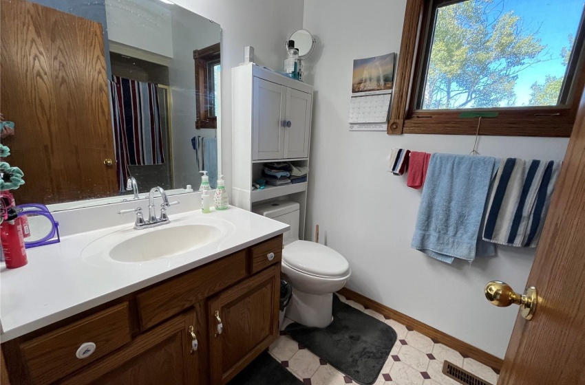 Bathroom with vanity, toilet, and tile patterned flooring