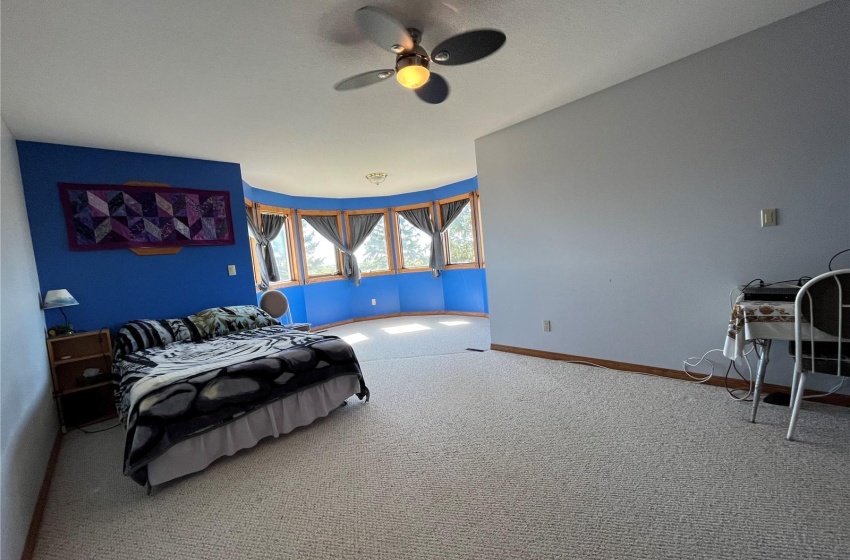 Bedroom featuring ceiling fan and carpet