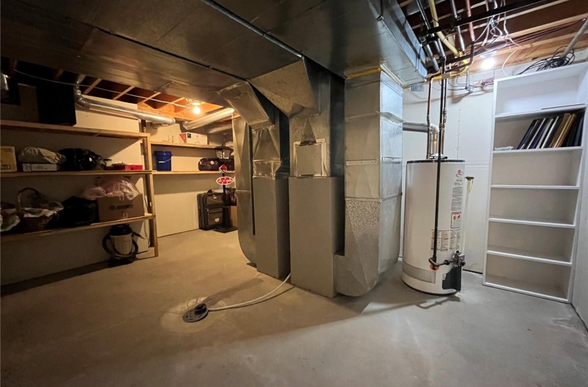 Basement featuring heating unit and water heater