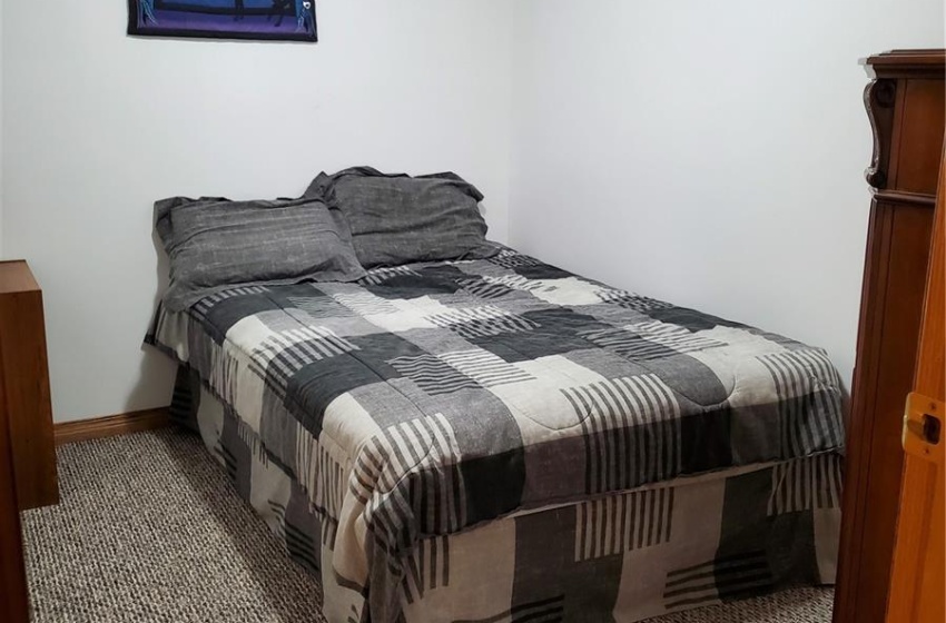 Bedroom featuring a paneled ceiling and carpet floors