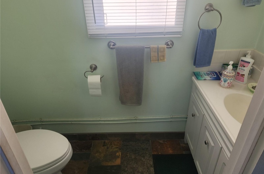 Bathroom featuring toilet, tile floors, and vanity