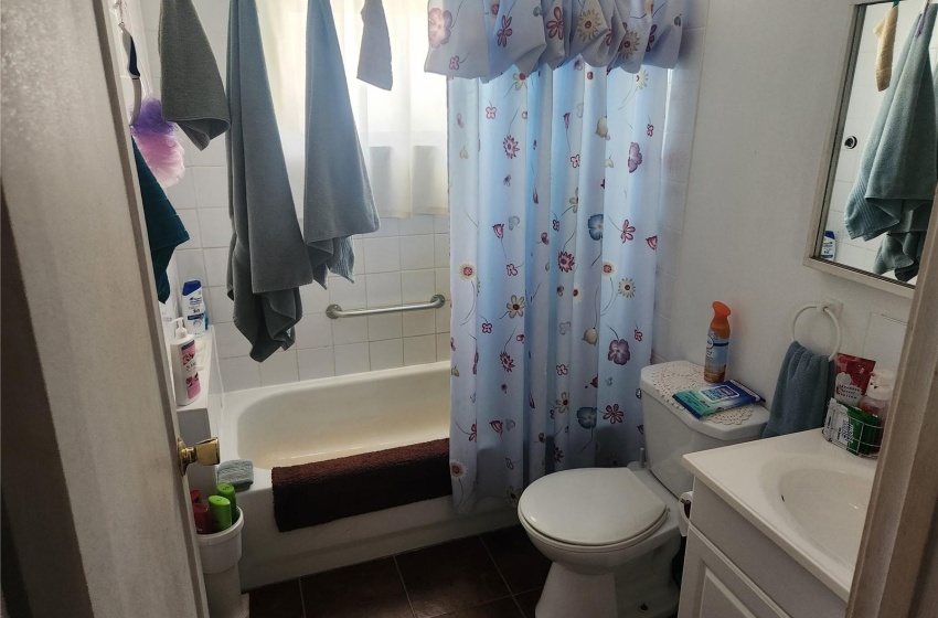 Full bathroom featuring shower / bath combination with curtain, tile flooring, toilet, and vanity