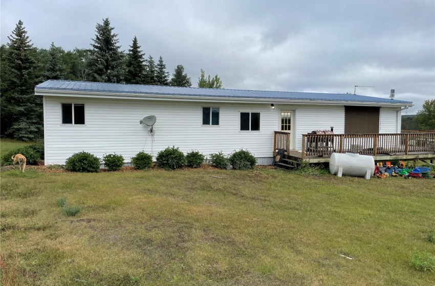 Rear view of house with a deck and a yard